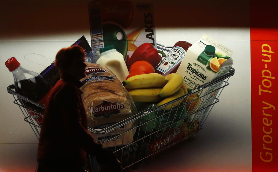 A woman walks past a grocery store in Loughborough, central England, January 10, 2013. Up to half of all the food produced worldwide ends up going to waste due to poor harvesting, storage and transport methods as well as irresponsible retailer and consumer behaviour, a report said on Thursday. REUTERS/Darren Staples   (BRITAIN - Tags: AGRICULTURE ENVIRONMENT FOOD BUSINESS)