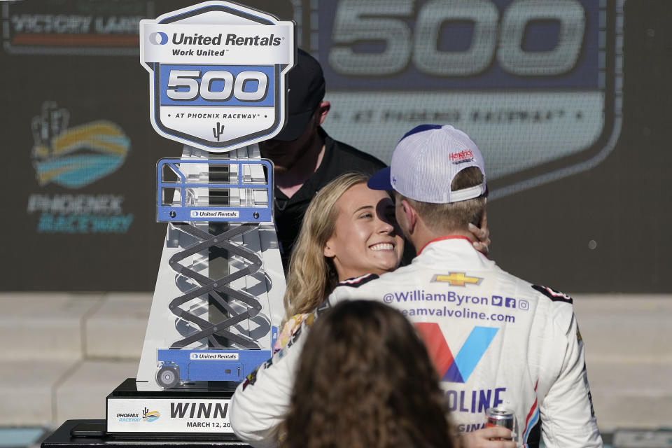 William Byron, right, is greeted by his girlfriend Erin Blaney after winning a NASCAR Cup Series auto race at Phoenix Raceway, Sunday, March 12, 2023, in Avondale, Ariz. (AP Photo/Darryl Webb)