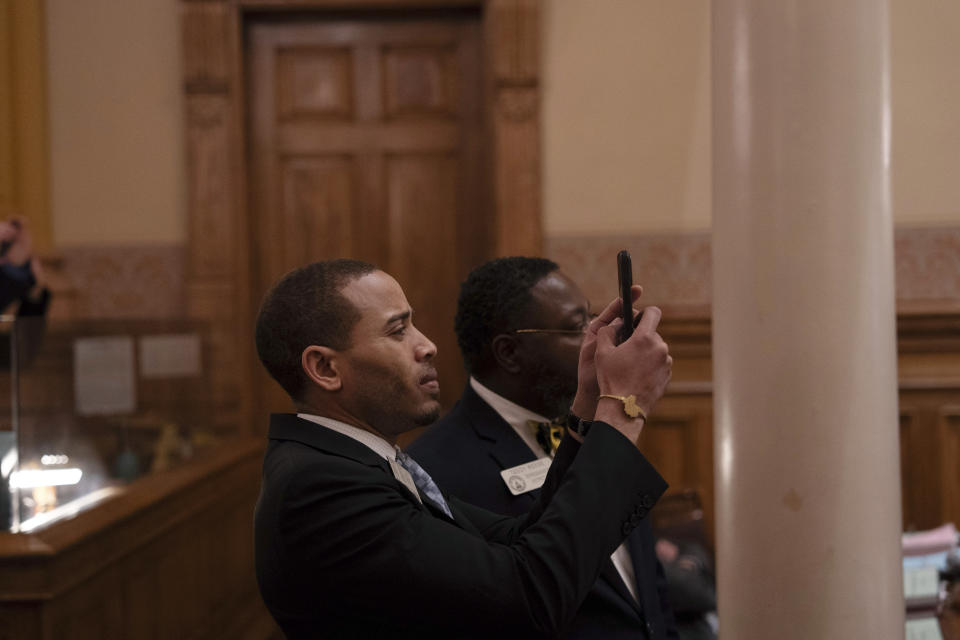 Georgia state Rep. Omari Crawford, D-Decatur, captures the state Senate's vote on a substitute of House Bill 1104, a measure that originally dealt with suicide prevention, but was radically overhauled in Senate committee by adding a number of other bills that had earlier failed to pass the Senate, Tuesday, March 26, 2024, in Atlanta. (Matthew Pearson/WABE via AP)