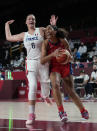 United States' A'Ja Wilson (9), right, drives around of France's Alexia Chartereau (6) during women's basketball preliminary round game at the 2020 Summer Olympics, Monday, Aug. 2, 2021, in Saitama, Japan. (AP Photo/Eric Gay)