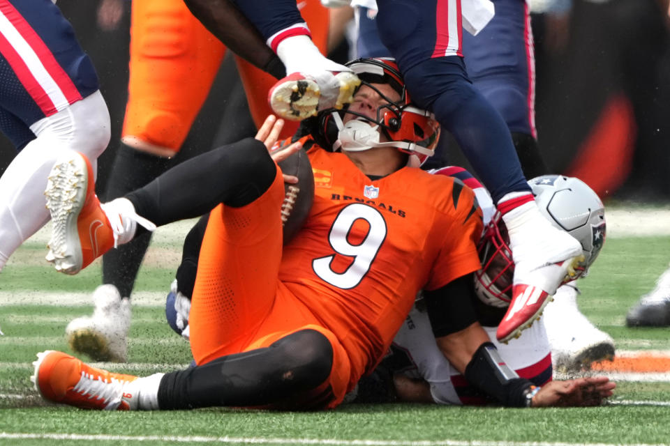 CINCINNATI, OHIO - SEPTEMBER 08: Joe Burrow #9 of the Cincinnati Bengals is hit in the helmet by the cleat of Jabrill Peppers #5 of the New England Patriots in the second quarter of the game at Paycor Stadium on September 08, 2024 in Cincinnati, Ohio. (Photo by Dylan Buell/Getty Images)