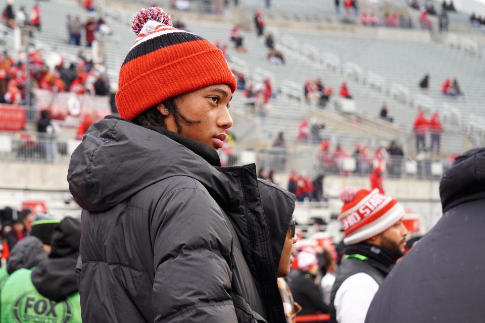 Recruit Chris Henry Jr. watches Ohio State warm up prior to the Buckeyes' game against Indiana.