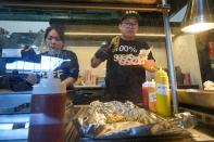 Workers prepare sushi at American Family Field in Milwaukee during an event to show off stadium foods Thursday, March 28, 2024. Most parks and arenas have a handful of areas that offer salads, gluten free or vegan offerings if fans are willing to hunt a little. But the vast majority of people attending baseball games aren't necessarily looking to eat healthy. (AP Photo/Morry Gash)