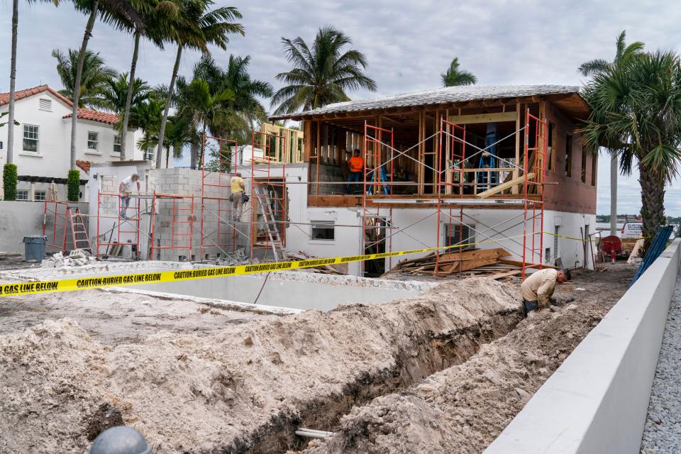 Workers remodel a 1954 home at 2745 South Flagler Drive in West Palm Beach. It was bought by Ritzzo Development in May 2021 for $2.1 million.