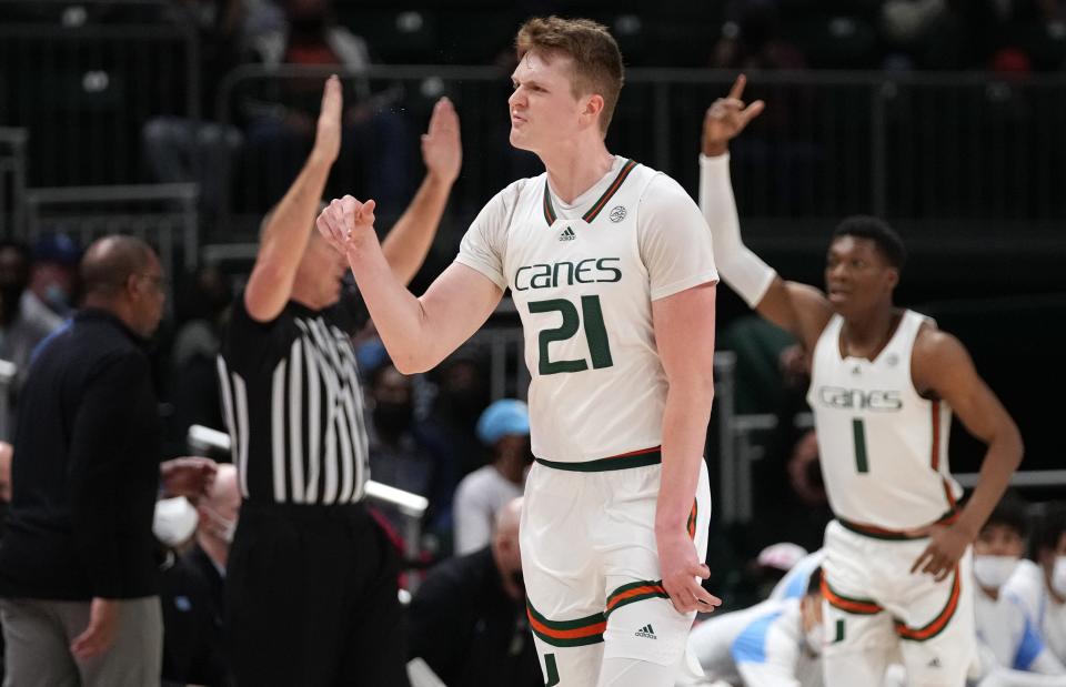 Jan 18, 2022; Coral Gables, Florida, USA; Miami Hurricanes forward Sam Waardenburg (21) reacts after making a three point shot against the North Carolina Tar Heels during the first half at Watsco Center. Mandatory Credit: Jasen Vinlove-USA TODAY Sports