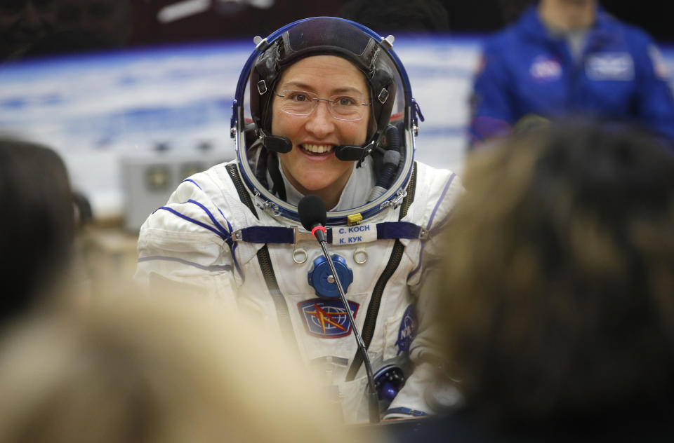 FILE - In this Thursday, March 14, 2019 file photo, U.S. astronaut Christina Koch, member of the main crew of the expedition to the International Space Station (ISS), speaks with her relatives through a safety glass prior the launch of Soyuz MS-12 space ship at the Russian leased Baikonur cosmodrome, Kazakhstan. Koch will remain on board until February, approaching but not quite breaking Scott Kelly’s 340-day U.S. record. (AP Photo/Dmitri Lovetsky, Pool)
