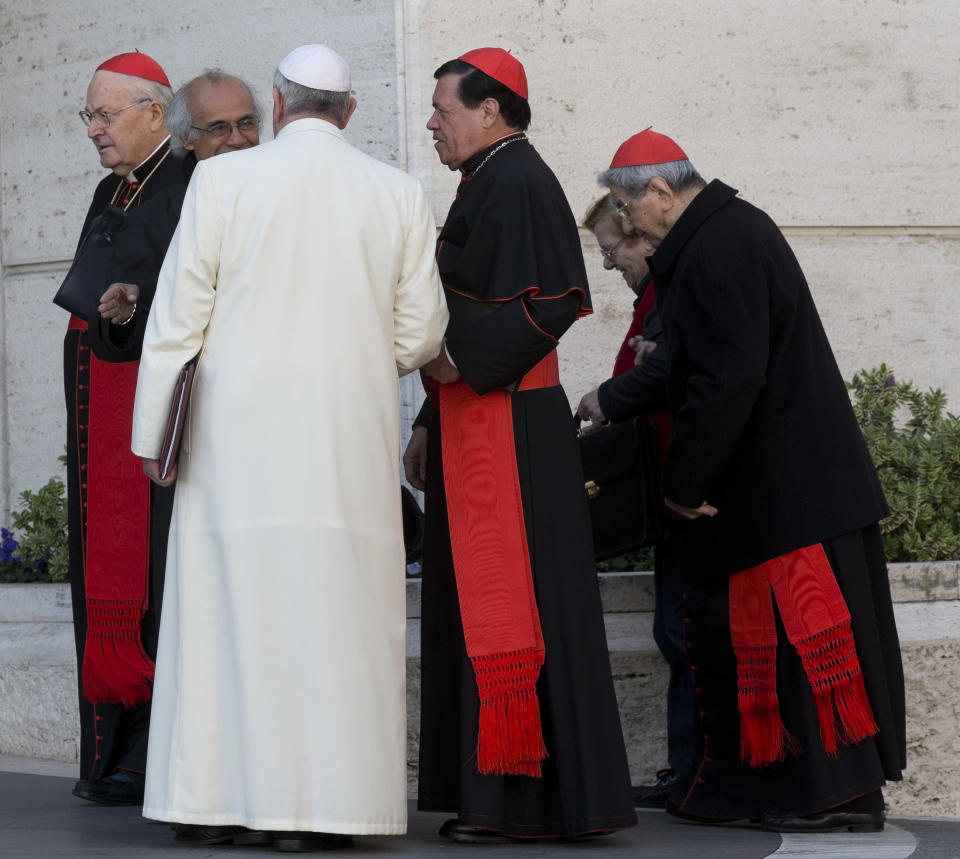 Pope Francis, flanked by cardinal Angelo Sodano, left, Managua archbishop Leopoldo Jose' Brenes Solorzano, second from right, and cardinal Norberto Rivera Carrera, arrives to open the morning session of an extraordinary consistory in the Synod hall at the Vatican City, Friday, Feb. 21, 2014. Pope Francis is leading a two-day meeting urging his cardinals to find "intelligent, courageous" ways to help families under threat today without delving into case-by-case options to get around Catholic doctrine. He said the church must find ways to help families with pastoral care that is "full of love."(AP Photo/Alessandra Tarantino)