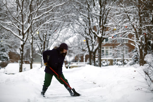 DETROIT, MI - JANUARY 6: Carly Strachan shovels several inches of snow from her sidewalk as the area deals with record breaking freezing weather January 6, 2014 in Detroit, Michigan. Michigan and most of the Midwest received their first major snow storm of 2014 last week and subzero temperatures are expected most of this week with wind-chill driving temperatures down to 50-70 degrees below zero. A 