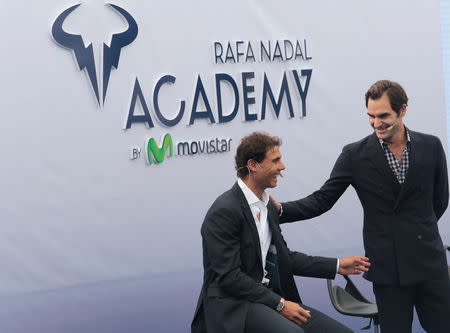 Switzerland's Roger Federer talks to Spain's Rafael Nadal during the opening ceremony of the Rafa Nadal tennis academy in Manacor, Spain, October 19, 2016. REUTERS/Enrique Calvo