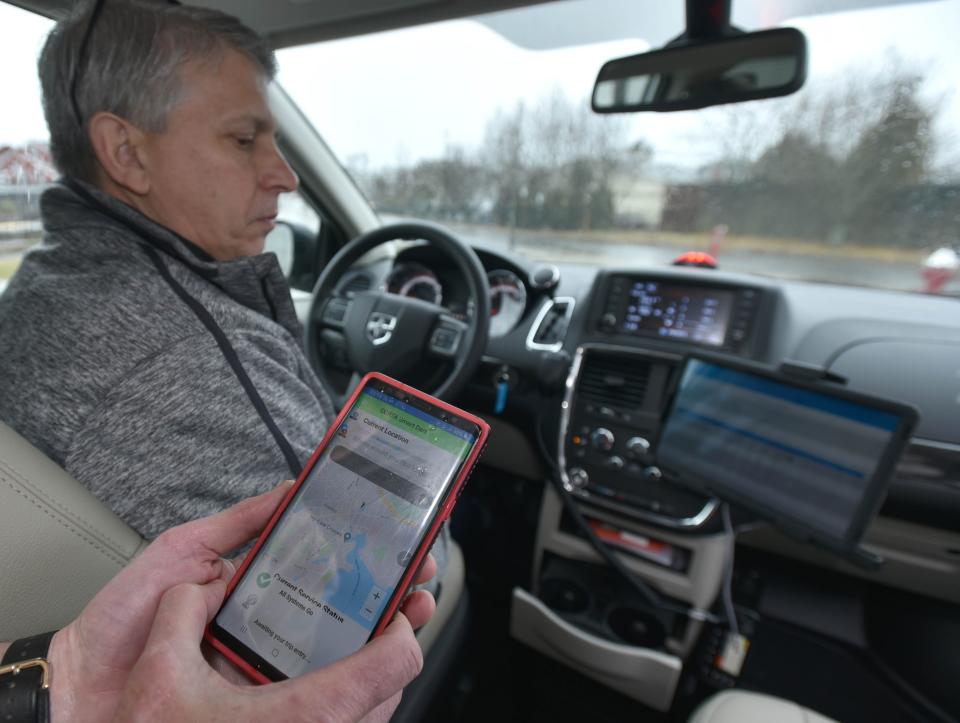 Tom Cahir fires up the SmartDart app on his phone inside one of the new Cape Cod Regional Authority vans as Dennis Foster takes the wheel on Feb. 11, 2020. The electric system for scheduling rides was disabled by a ransomware attack over the Memorial Day weekend but CCRTA shifted to manual scheduling. Steve Heaslip/Cape Cod Times