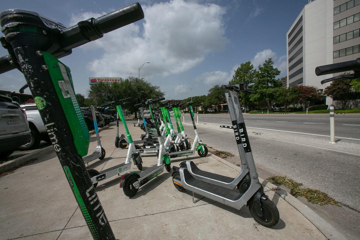 Austin has 10,250 permitted electric scooters, like these grouped together on Congress Avenue, within its city limits, but only 6,000 (1,500 per provider) are allowed to be deployed downtown.