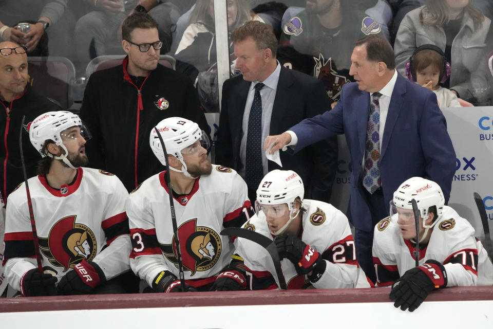 Ottawa Senators interim coach Jacques Martin, right, talks to players during the third period of the team's NHL hockey game against the Arizona Coyotes, Tuesday, Dec. 19, 2023, in Tempe, Ariz. (AP Photo/Rick Scuteri)