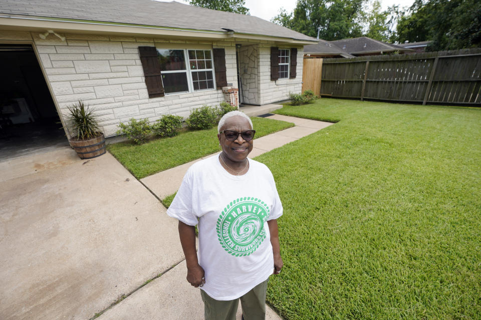 Doris Brown poses outside her home Friday, July 31, 2020, in Houston. Brown's home flooded during Harvey and she's part of a group called the Harvey Forgotten Survivors Caucus. (AP Photo/David J. Phillip)