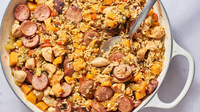 sweet potato jambalaya in a skillet with metal spoon