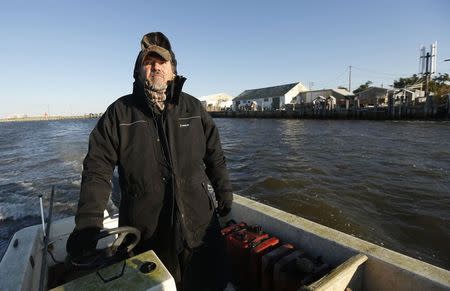 Saxis Island resident and duck decoy carver Grayson Chesser takes to the water off this historic fishing village on Virginia's Eastern Shore, October 25, 2013. REUTERS/Kevin Lamarque