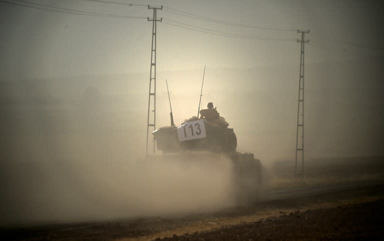 A Turkish army tank drives towards Syria in the Turkish border city of Karkamis on August 24, 2016