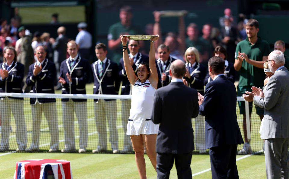 France's Marion Bartoli lifts the trophy after beating Germany's Sabine Lisicki during day twelve of the Wimbledon Championships at The All England Lawn Tennis and Croquet Club, Wimbledon.