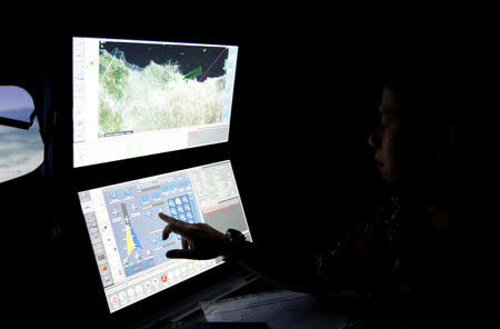 FILE PHOTO: A senior pilot of Lion Air Group points at the control computer as he supervises during a routine practice session on Boeing 737-900ER simulator at Angkasa Training Center near Jakarta, Indonesia, November 2, 2018. REUTERS/Willy Kurniawan/File Photo