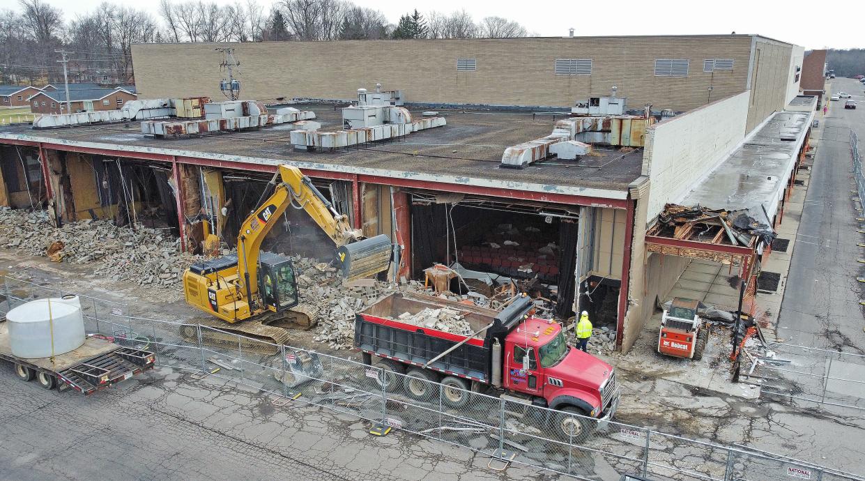 The west walls of the former Kingsgate Cinema are demolished Tuesday morning, exposing the seats of one of the theaters.