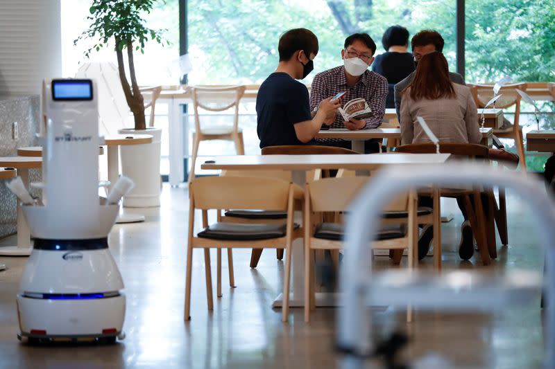 Customers place an order at a cafe where a robot that takes orders, makes coffee and brings the drinks straight to customers is being used in Daejeon