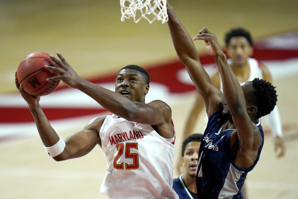 Maryland forward Jairus Hamilton (25) goes up for a shot against St. Peter's forward KC Ndefo during the first half of an NCAA college basketball game, Friday, Dec. 4, 2020, in College Park, Md. (AP Photo/Julio Cortez)