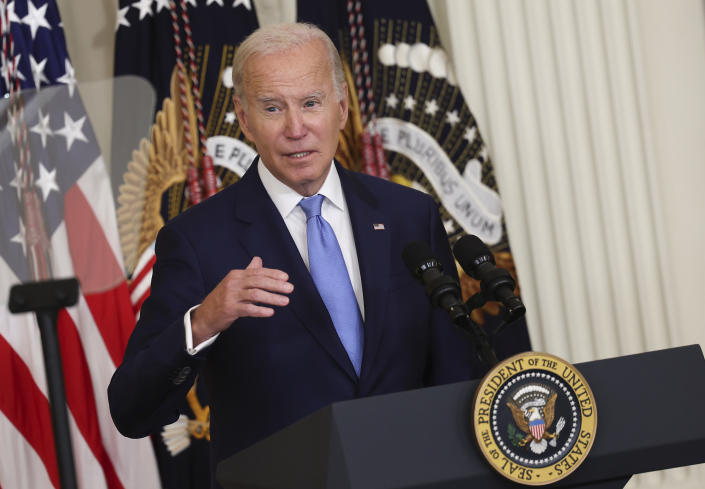 President Biden delivers remarks at a podium marked with the presidential seal.