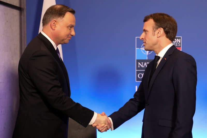 FILE PHOTO: France's President Emmanuel Macron greets Poland's President Andrzej Duda during a meeting at a NATO summit in Britain