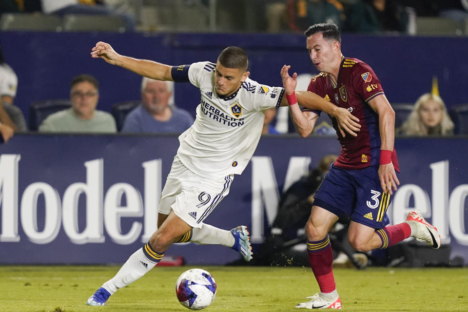 LA Galaxy forward Dejan Joveljic, left, and Real Salt Lake defender Bryan Oviedo vie for the ball during the second half of an MLS soccer match Saturday, Oct. 14, 2023, in Carson, Calif. (AP Photo/Ryan Sun)