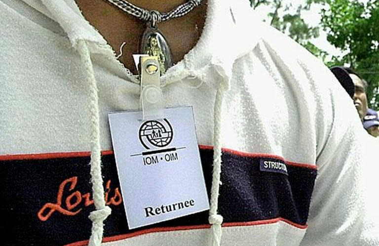 A Cambodian man with an IOM (International Organization for Migration) card reading "returnee" waits at an immigration centre in Phnom Penh, after being forced into slavery on Thai trawlers