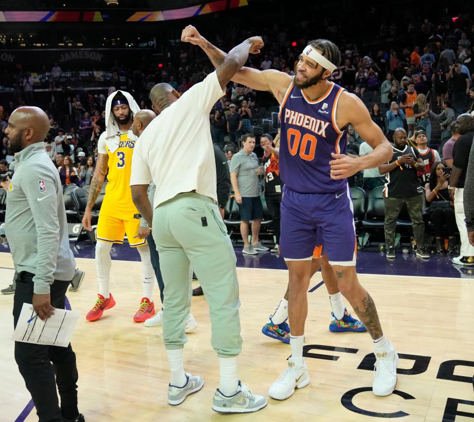 Los Angeles Lakers forward LeBron James (left) greets Phoenix Suns center JaVale McGee (00) after losing 121-110 at Footprint Center.