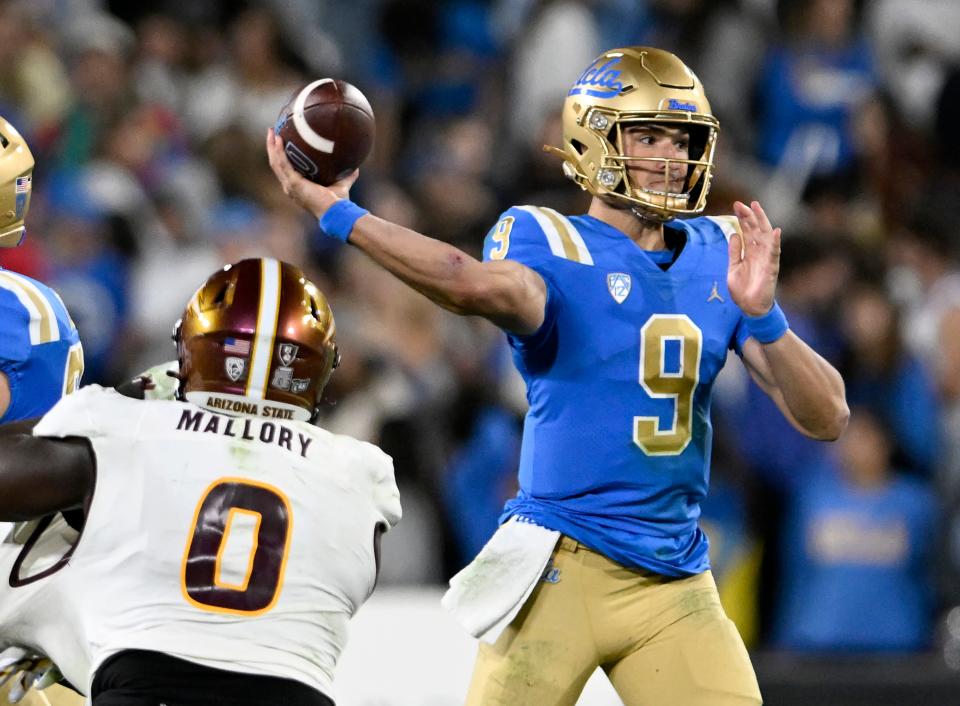 Nov 11, 2023; Pasadena, California, USA; UCLA Bruins quarterback Collin Schlee passes the ball over Arizona State Sun Devils defensive back Dashaun Mallory during the first half at the Rose Bowl.