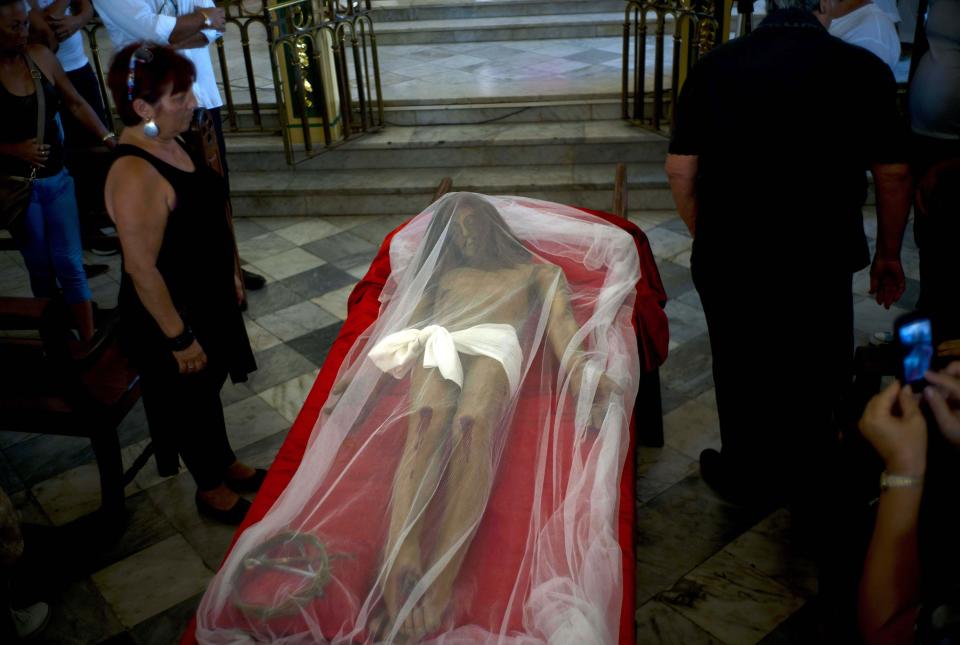 A statue of Jesus Christ covered with a shroud lies inside a church before a Holy Week procession on Good Friday in Regla, a town just across the bay from Havana, Cuba, Friday, April 14, 2017. Holy Week commemorates the last week of the earthly life of Jesus Christ culminating in his crucifixion on Good Friday and his resurrection on Easter Sunday. (AP Photo/Ramon Espinosa)