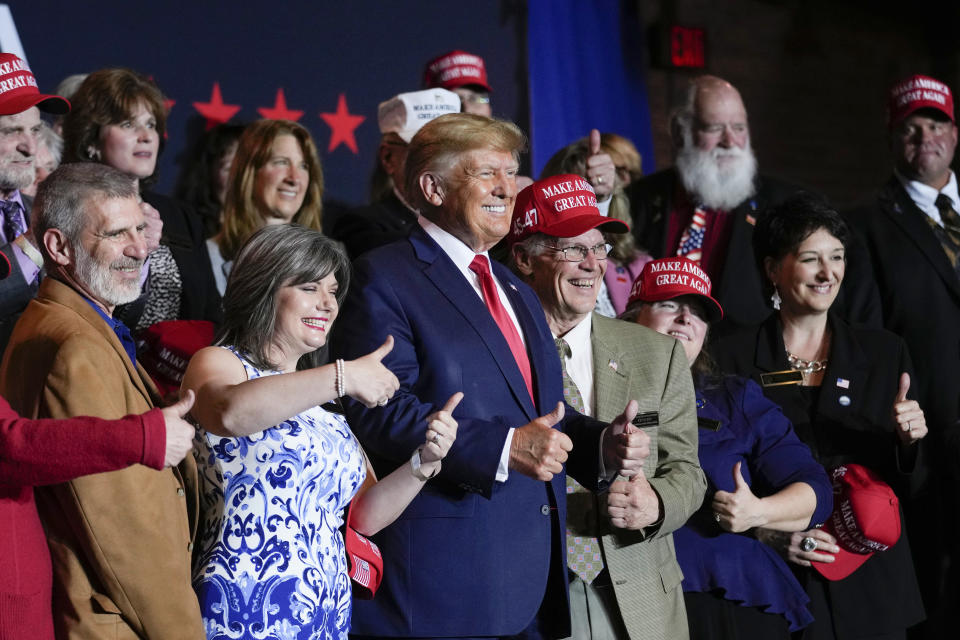 FILE - Former President Donald Trump poses for a photo with supporters after speaking at a campaign event Thursday, April 27, 2023, in Manchester, N.H. He's a criminal defendant, a businessman and a politician. But to his most loyal supporters, Donald Trump will always be Mr. President. When it comes to signaling our political loyalities, language can be just as telling as a MAGA cap, offering a simple by subtle reminder of the false election claims that continue to reverberate online, as well as the polarization that has gripped our politics and divided our people. (AP Photo/Charles Krupa, File)