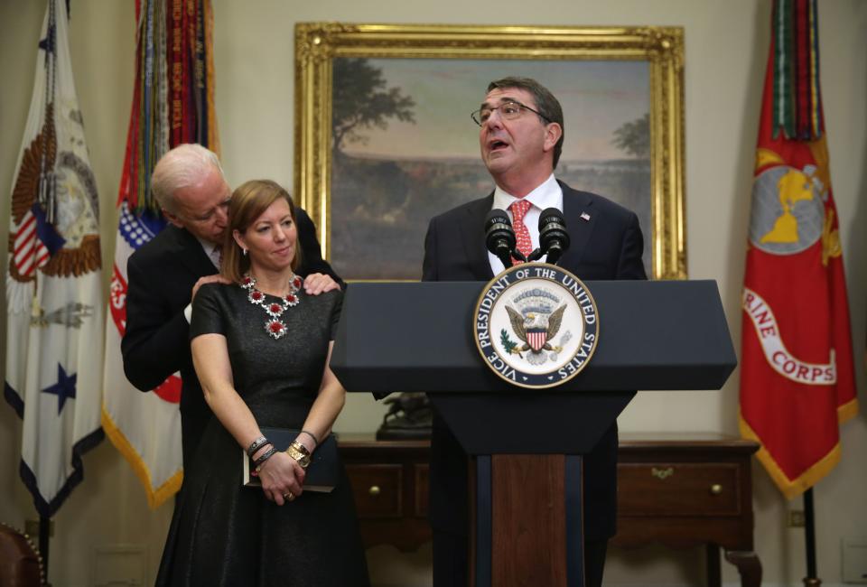 Ashton Carter, right, makes remarks after he was sworn in as Secretary of Defense, as his wife Stephanie and Vice President Joe Biden listen in the Roosevelt Room of the White House in Washington, Feb. 17, 2015