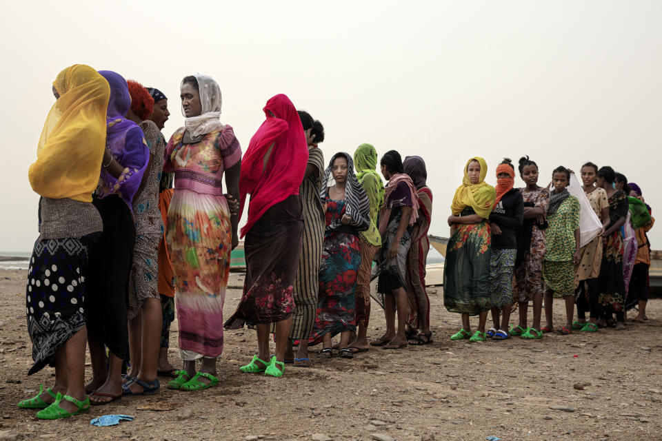 In this July 25, 2019 photo, Ethiopian Tigray migrants stand in line as they are counted by smugglers after arriving to the coastal village of Ras al-Ara from Djibouti, in Lahj, Yemen. According to the U.N.'s International Organization for Migration the number of women making the trip jumped from nearly 15,000 in 2018 to more than 22,000 in 2019. (AP Photo/Nariman El-Mofty)