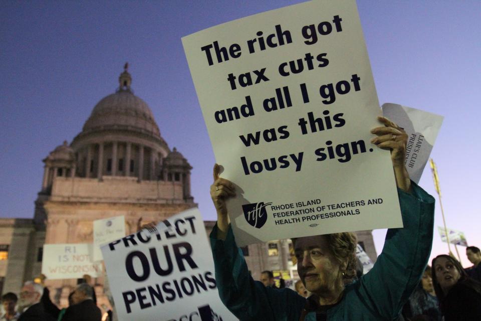 In this file photo from 2011, Falck Donnelly, a former Providence school teacher retired for six years, joins a rally of union groups and Occupy Providence activists in protesting cuts in pension benefits.