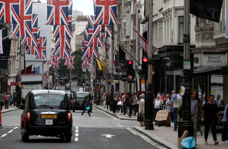 Shoppers walk past stores on New Bond Street in London, Britain July 9, 2016. REUTERS/Peter Nicholls