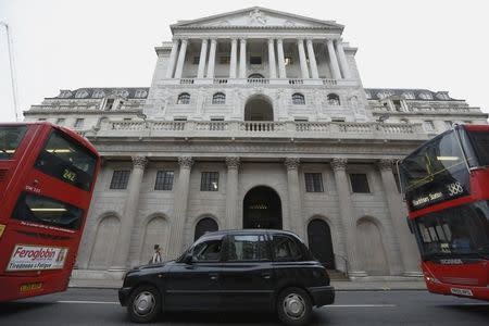 A taxi and buses queue outside the Bank of England in London, Britain December 10, 2015. REUTERS/Luke MacGregor