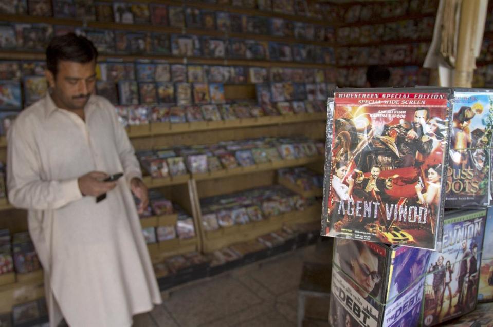 Newly released Bollywood film 'Agent Vinod' is displayed top right, for sale at a video shop in Rawalpindi, Pakistan, on Monday, March 26, 2012. The Indian James Bond, Agent Vinod, can disarm a bomb while flying a helicopter, dodge bullets from deadly assassins and save his country from nuclear disaster, but getting into cinemas in Pakistan has proved to be an impossible feat, after Agent Vinod's critical portrayal of the country's generals and spies and shows Pakistan providing support for the Taliban in Afghanistan.(AP Photo/Anjum Naveed)