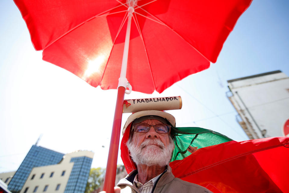 Man holding red parisol