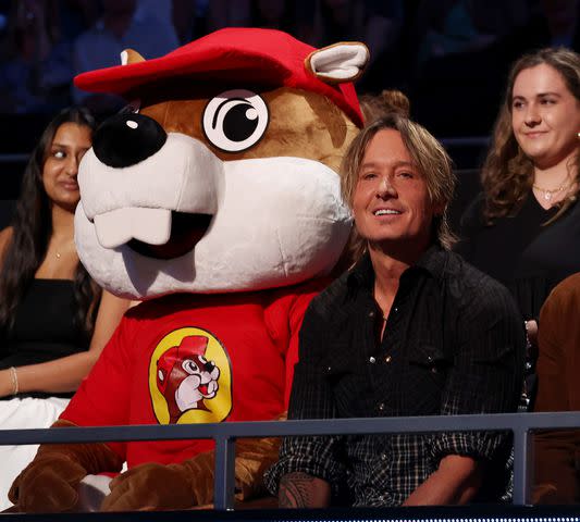 <p>Kevin Mazur/Getty</p> Bucky The Beaver of Buc-ee's and Keith Urban attend the 2024 CMT Awards at Moody Center on April 7, 2024 in Austin, Texas