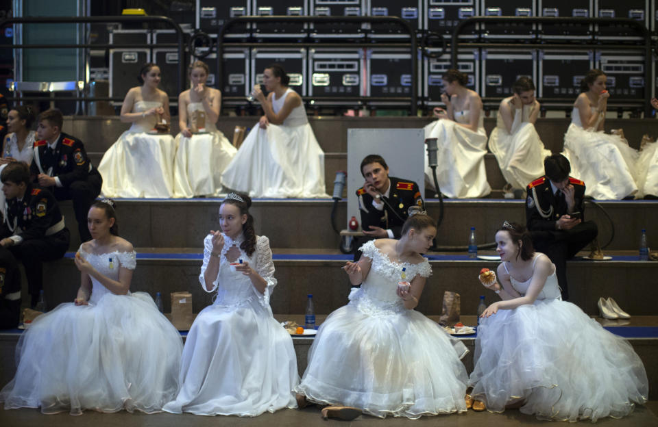 Military school students sit backstage during an annual ball in Moscow, Russia, Tuesday, Dec. 11, 2018. In a revival of a czarist tradition, more than 1,000 students both from military and general schools travelled to the capital from across the country to participate. (AP Photo/Alexander Zemlianichenko)