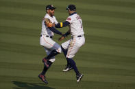 Houston Astros' George Springer, left, celebrates with Carlos Correa after the Astros defeated the Oakland Athletics in Game 4 of a baseball American League Division Series in Los Angeles, Thursday, Oct. 8, 2020. (AP Photo/Marcio Jose Sanchez)