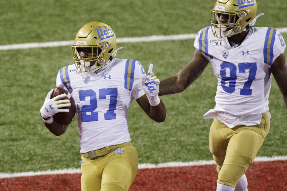 UCLA running back Joshua Kelley (27) runs for a touchdown in front of teammate Jordan Wilson (87) during the first half of an NCAA college football game against Washington State in Pullman, Wash., Saturday, Sept. 21, 2019. (AP Photo/Young Kwak)