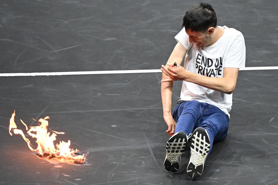 A protestor sets himself alight wearing a t-shirt saying 'End UK Private Jets' Laver Cup, Tennis Tournament, Day One, 02 Arena, London, UK - 23 Sep 2022