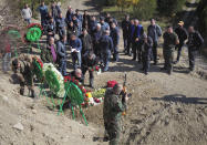 People bury their relative and friend killed during a military conflict, at a cemetery in Stepanakert, the separatist region of Nagorno-Karabakh, Sunday, Oct. 18, 2020. Armenia and Azerbaijan are trading accusations of violating the new cease-fire in their conflict over the separatist Nagorno-Karabakh territory despite a true announced Saturday that was supposed to take effect at midnight. It is a second attempt to establish a cease-fire in the region since heavy fighting there broke out on Sept. 27. (AP Photo)