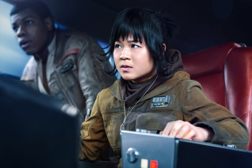 A man and a woman at a switchboard inside a spaceship