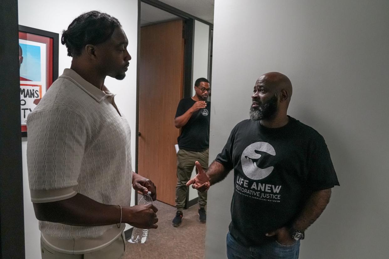 Life Anew program manager Sean Oliver, right, talks to Kiermet Hyder, the chief operations officer of the Hungry Hill Foundation, before Wednesday's special community event at the Harvest Trauma Recovery Center for community members to talk with therapists and each other following Saturday's Juneteenth celebration shooting in Round Rock.