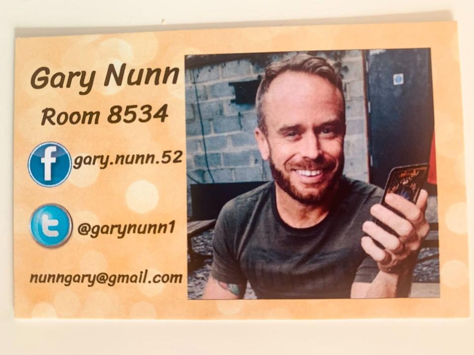 the writer's business card with his social media, photo, and room number