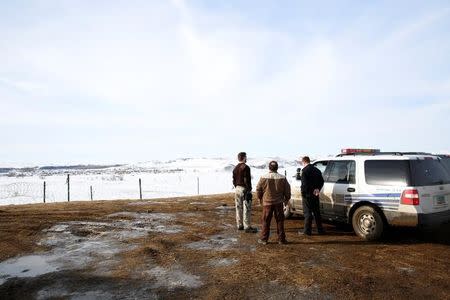 Police monitor the outskirts of the Dakota Access oil pipeline protest camp near Cannon Ball, North Dakota, U.S., January 29, 2017. REUTERS/Terray Sylvester